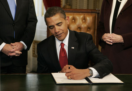 U.S. President Barack Obama signs his first act as president, a proclamation, after being sworn in as the 44th President of the United States in Washington